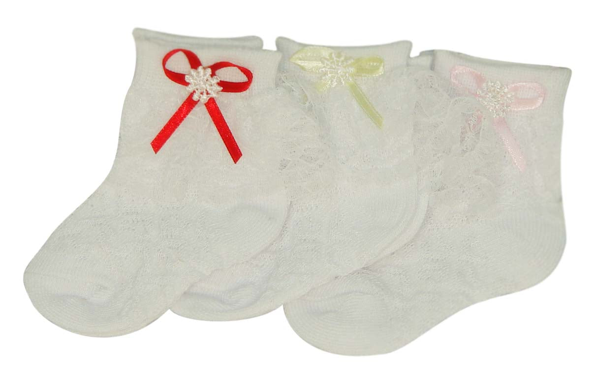Three pairs of baby socks with decorative bows on a white background