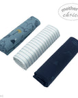 Three rolled-up towels in blue, white, and navy with 'Mother's Choice' branding on a white background.