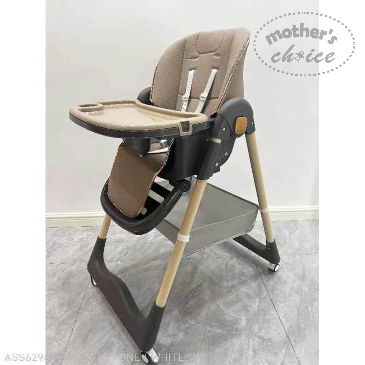 Baby high chair with tray on a gray floor, branded 'Mother's Choice'.