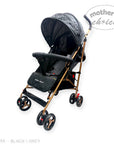 Black and grey stroller with gold accents on a white background