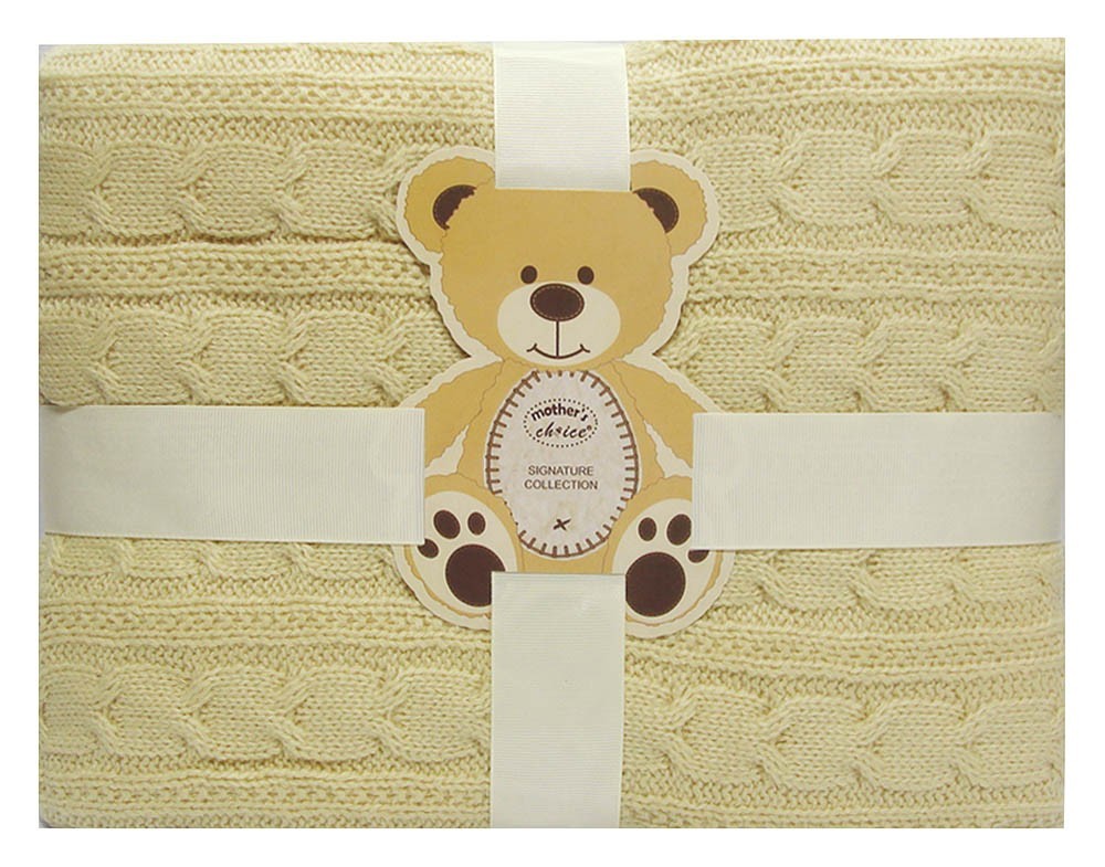 Beige textured blanket with a teddy bear tag featuring 'Mothercare' branding.
