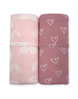 Two folded fabric swaddles with rainbow and heart patterns on a white background