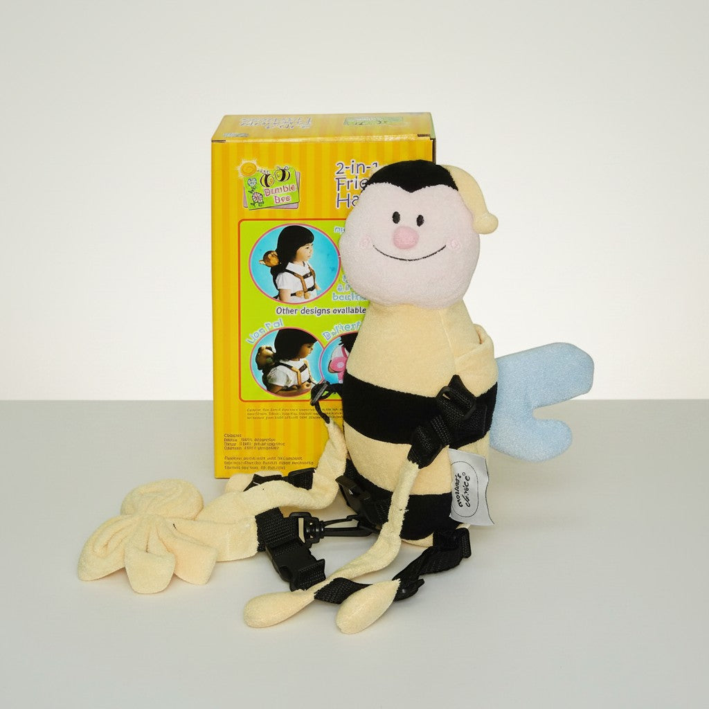 Stork And Baby Mothers Choice 2-in-1 Bee Harness, a plush bumblebee with black stripes and blue wings, featuring adjustable straps and a detachable rein.