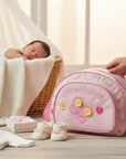 Mothers Choice Small Round Day Pack Pink, a compact and cute baby bag with butterfly embroidery and "cute as a button" text.