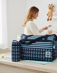 Stork And Baby Anchor Diaper Bag with matching bottle holder, navy blue with white anchors and blue stripes.