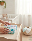 Stork And Baby 3 pack of soft baby hooded towels with turtle and star prints on a wooden changing table