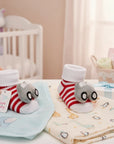 Stork And Baby red and white striped baby socks with grey car rattle, soft cotton blend, gift set.