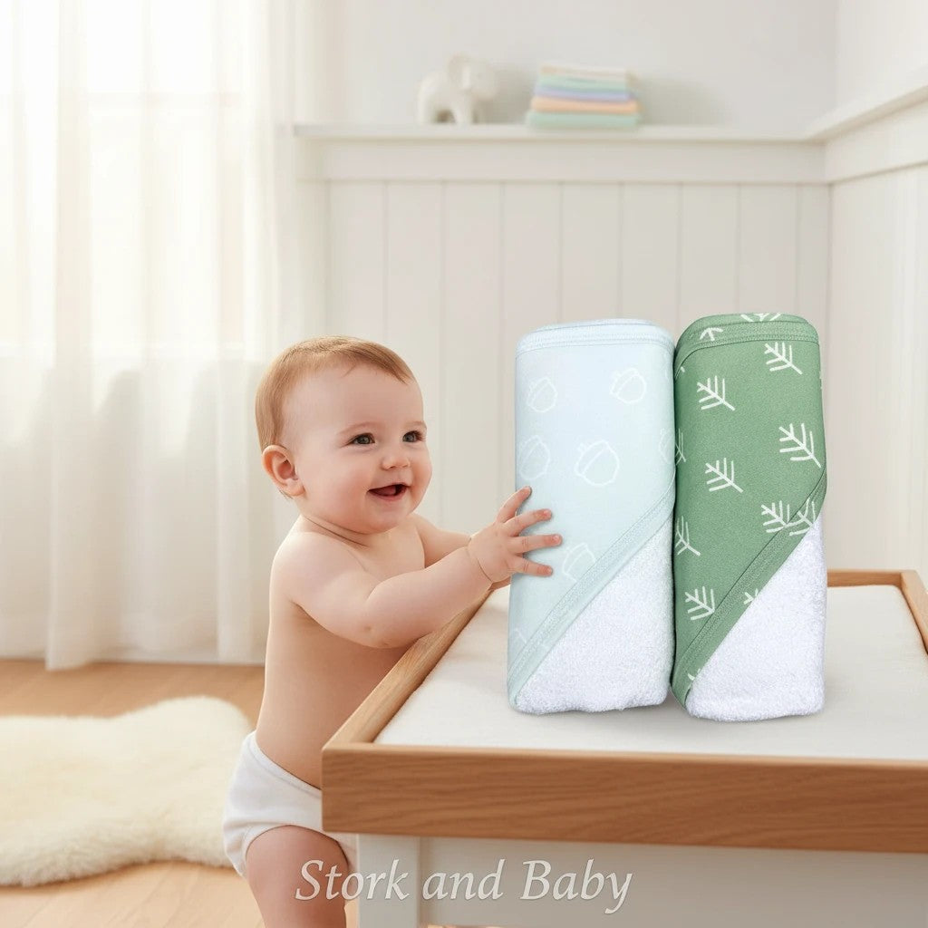 Stork and Baby Mothers Choice 2-pack sage green bamboo hooded towels with acorn and leaf prints.