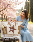 Stork And Baby beige nappy bag with brown star and "No.1" graphic, spacious interior, smart compartments, perfect for daily outings.