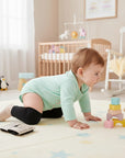 Stork And Baby black non-slip knee guards with grip dots for crawling babies.