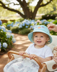 Stork And Baby light blue cotton bucket hat with embroidered flowers and butterflies for a baby girl.