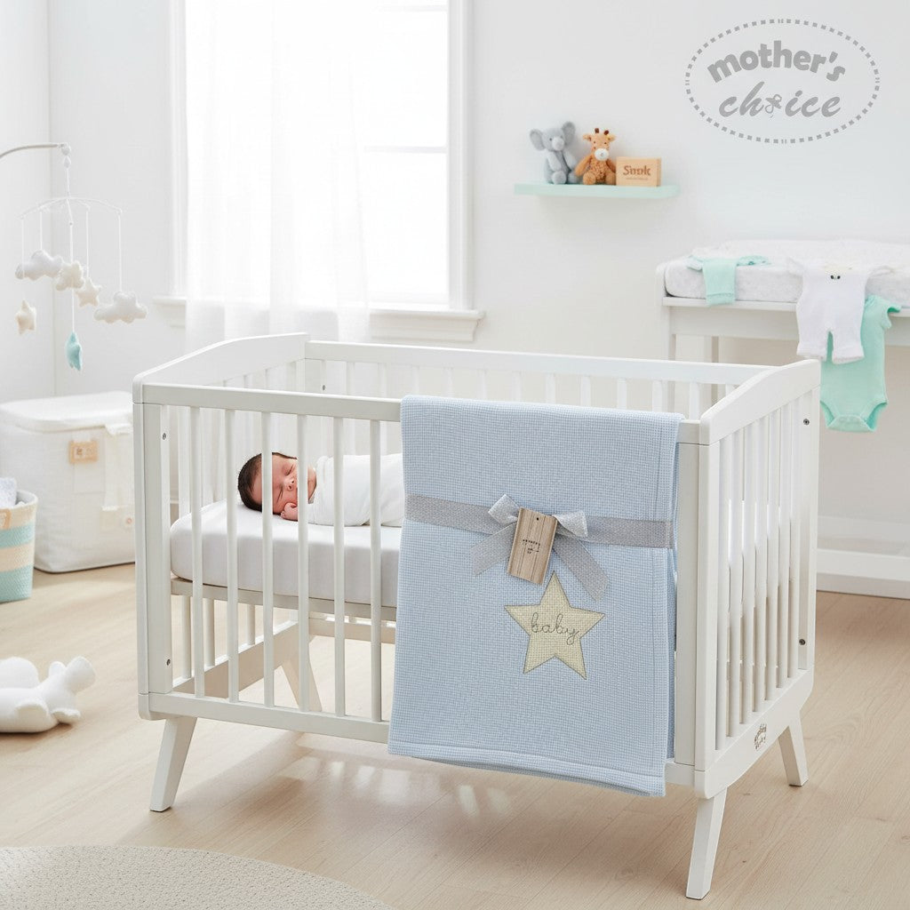 Stork And Baby blue cotton waffle blanket with yellow star embroidery and "baby" text. Tied with grey ribbon.