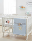 Stork And Baby blue cotton waffle blanket with yellow star embroidery and "baby" text. Tied with grey ribbon.
