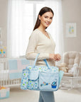 Stork And Baby blue Mothers Choice diaper bag with I Love Shower print, featuring two outer pockets in a nursery.