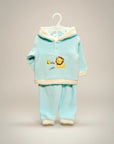 Stork And Baby light blue coral fleece tracksuit with cream trim and a lion graphic. Features a hood and long sleeves.