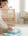 Stork And Baby light blue coral fleece tracksuit with lion embroidery and white trim. Cozy baby outfit.