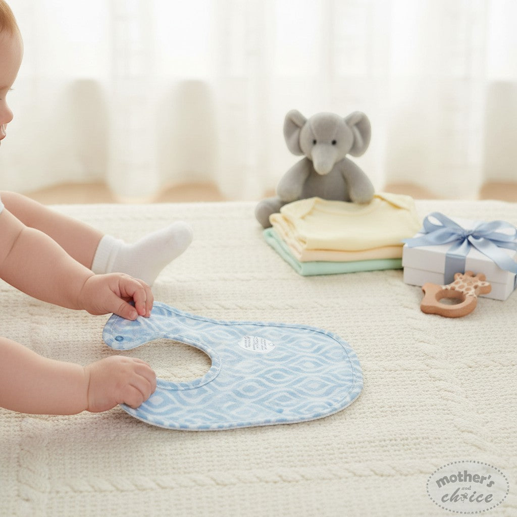 Stork And Baby blue patterned muslin bib for baby feeding and drool protection. Soft, breathable fabric.