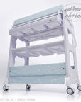 Stork And Baby blue baby bath caddy with star pattern, multiple storage shelves, and wheels for easy mobility