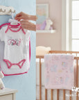 Stork and Baby white 100% cotton baby bodysuit with pink trim and 'I'm Fancy' graphic. Short sleeves with polka dots.