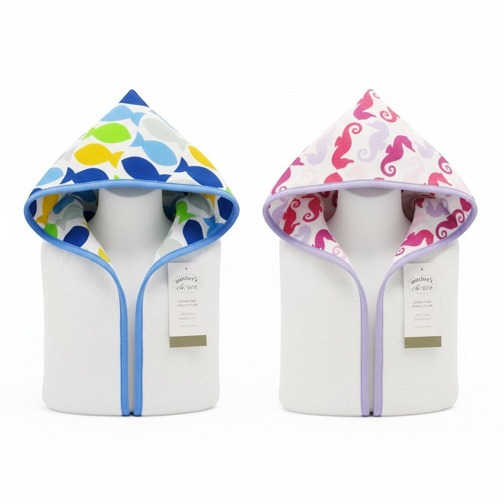 Stork And Baby white 100% cotton hooded towels with playful sea creature prints in fish blue and seahorse pink.