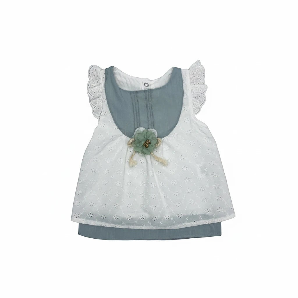 Stork And Baby white cotton linen dress with blue accents and a green flower embellishment. Features eyelet fabric and ruffled sleeves.