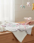 Stork And Baby white 100% cotton baby girl rompers with pink trim and butterfly or floral appliques. Includes matching booties.
