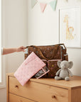 Stork And Baby brown microfibre diaper bag with embroidered circles and pink trim. Includes changing pad.