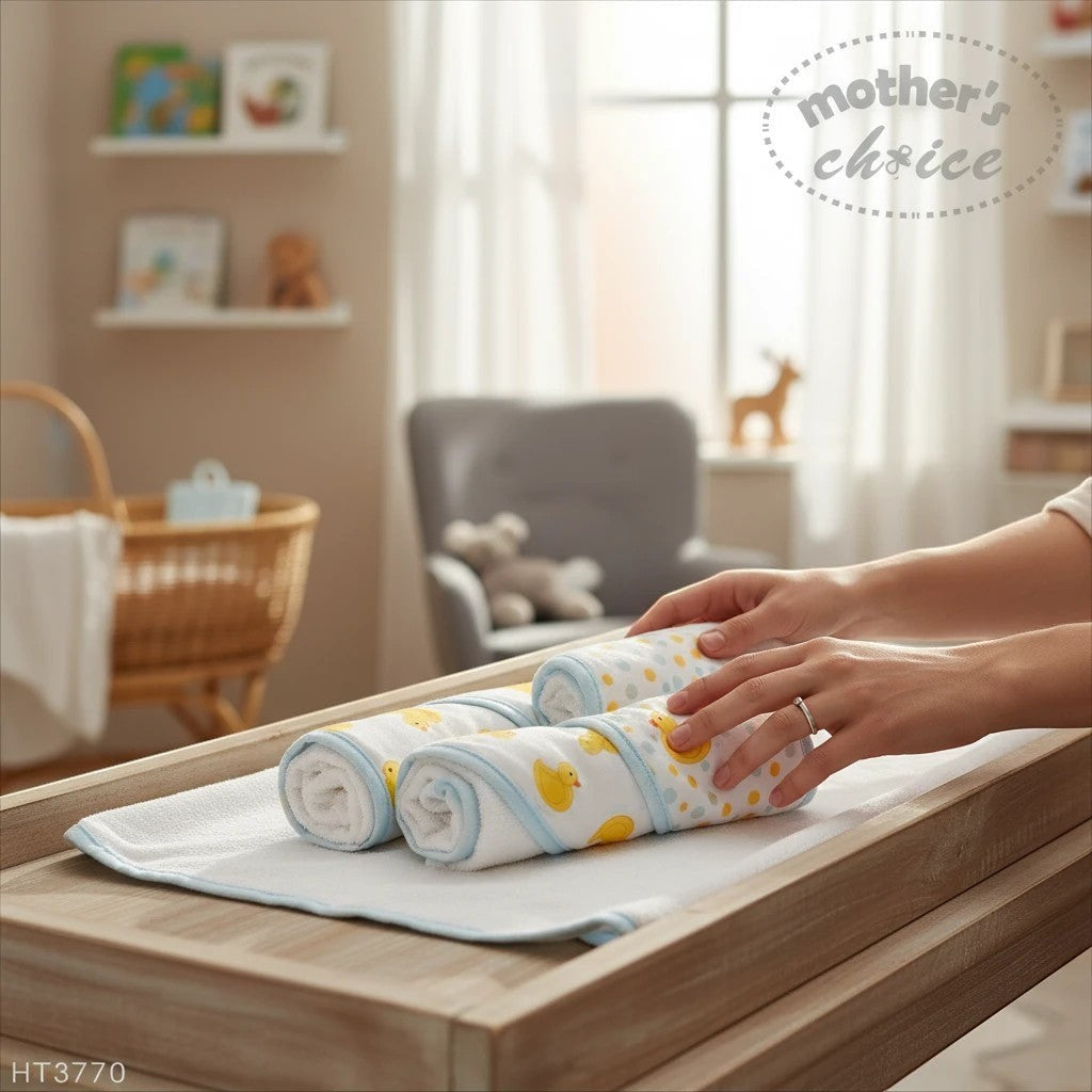 Stork And Baby Mothers Choice 3 pack baby hooded towels with yellow duck print and blue trim on a changing table