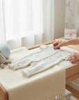 Stork And Baby light blue floral baby romper with short sleeves and ruffled ankles. Soft cotton fabric.