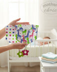Stork And Baby Mothers Choice 2 pack bandana bibs with giraffe print and attached teethers. One bib has pink and blue polka dots.