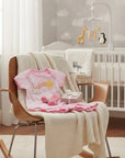 Stork and Baby Girls Rainbow 3-piece set: pink striped bodysuit with rainbow and sun, pink socks, and ruffled shorts.