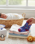 Stork And Baby Girls 2 pack socks, one with cupcakes, one with colorful polka dots. Soft cotton blend.