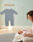 Stork And Baby grey cotton babygrow with elephant detail, on hanger, with mother and newborn baby.