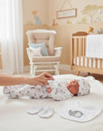 Stork And Baby 5 piece Grey Elie newborn starter set with elephant print, including bodysuit, hat, mittens, and bib.