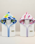 Stork And Baby white 100% cotton hooded towels with playful sea creature prints in blue fish and pink seahorse designs.