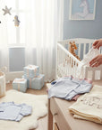 Stork And Baby light blue and pink knit cardigans for infants, soft and comfortable for babies.