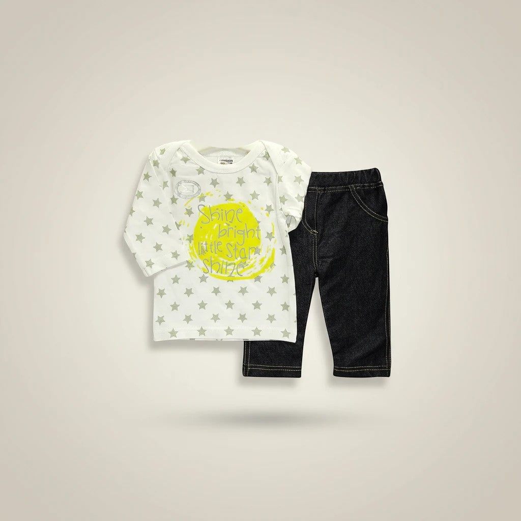 Stork And Baby white long-sleeve top with grey stars and yellow "Shine Bright Little Star" graphic, paired with dark wash stretch denim pants.