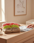 Stork And Baby brand infant jerseys in pink, coral, lime green, tan, and light blue. Soft knit fabric, button front.