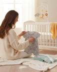 Stork And Baby grey cotton blend infant romper with a geometric triangle print. Short sleeves and button neck.