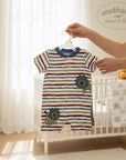 Stork And Baby infant's short-sleeve romper with horizontal stripes in red, blue, and green, featuring two lion appliques. 60% cotton, 40% polyester.