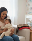 Stork And Baby infants cardigans in brown and red, soft knit, perfect for layering. A mother holds her baby.