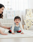 Stork And Baby red and navy knee guards for babies learning to crawl, protecting knees from rough surfaces.