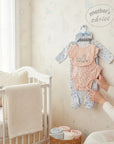 Stork And Baby Mothers Choice 5-piece baby layette set with ducks and squirrels print. Includes bodysuit, bib, footed pajamas, hat, and mittens.
