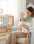 Stork And Baby Mothers Choice Sage Bamboo 2Pk Burp Cloths with a mother holding her baby in a nursery.