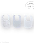 Stork And Baby Mothers Choice 3 pack of white baby bibs, one with a subtle grey animal print.