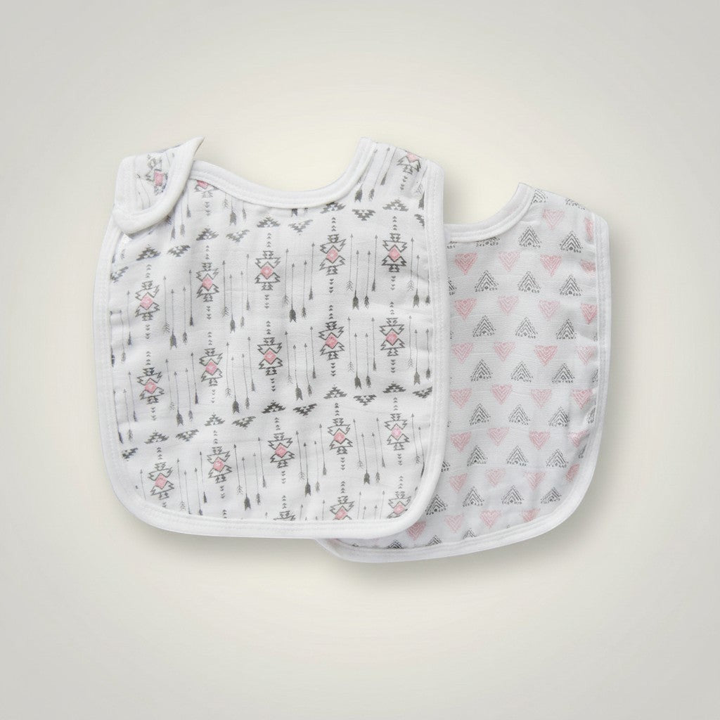Stork And Baby 2 pack muslin bibs with white, grey, and pink arrows and heart patterns. Lightweight and breathable.