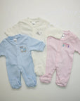 Stork And Baby pastel pink, blue, and cream 100% cotton babygrows with footies. Pink has 'dreamer' embroidery.