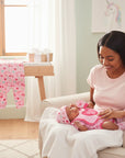 Stork And Baby pink 4-piece baby girl's outfit set with heart and candy cane print, includes footie pajama, bodysuit, bib, and hat.