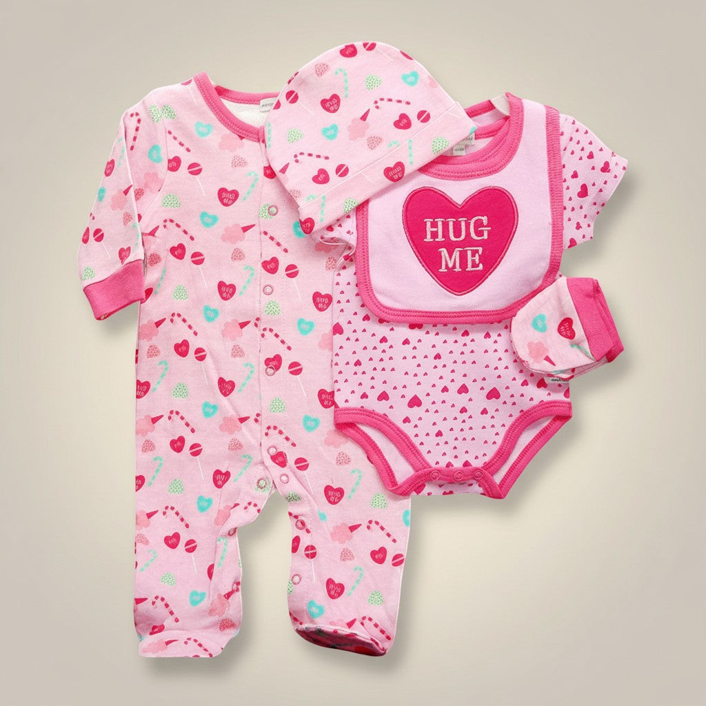 Stork And Baby pink 4-piece baby girl's outfit set with footie pajamas, bodysuit, bib, and hat featuring heart and candy prints.