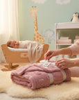 Stork And Baby pink single layer jacquard baby blanket with heart pattern, tied with a white ribbon.